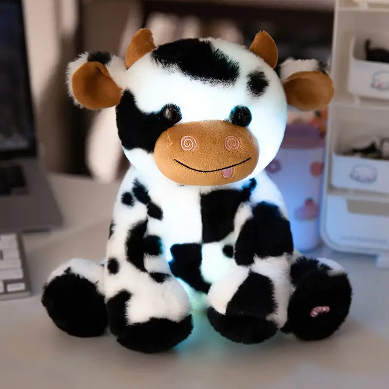 Zorg voor een knusse sfeer met de zachte en verlichte LumiCow - Knuffel Koe Met LED Verlichting.