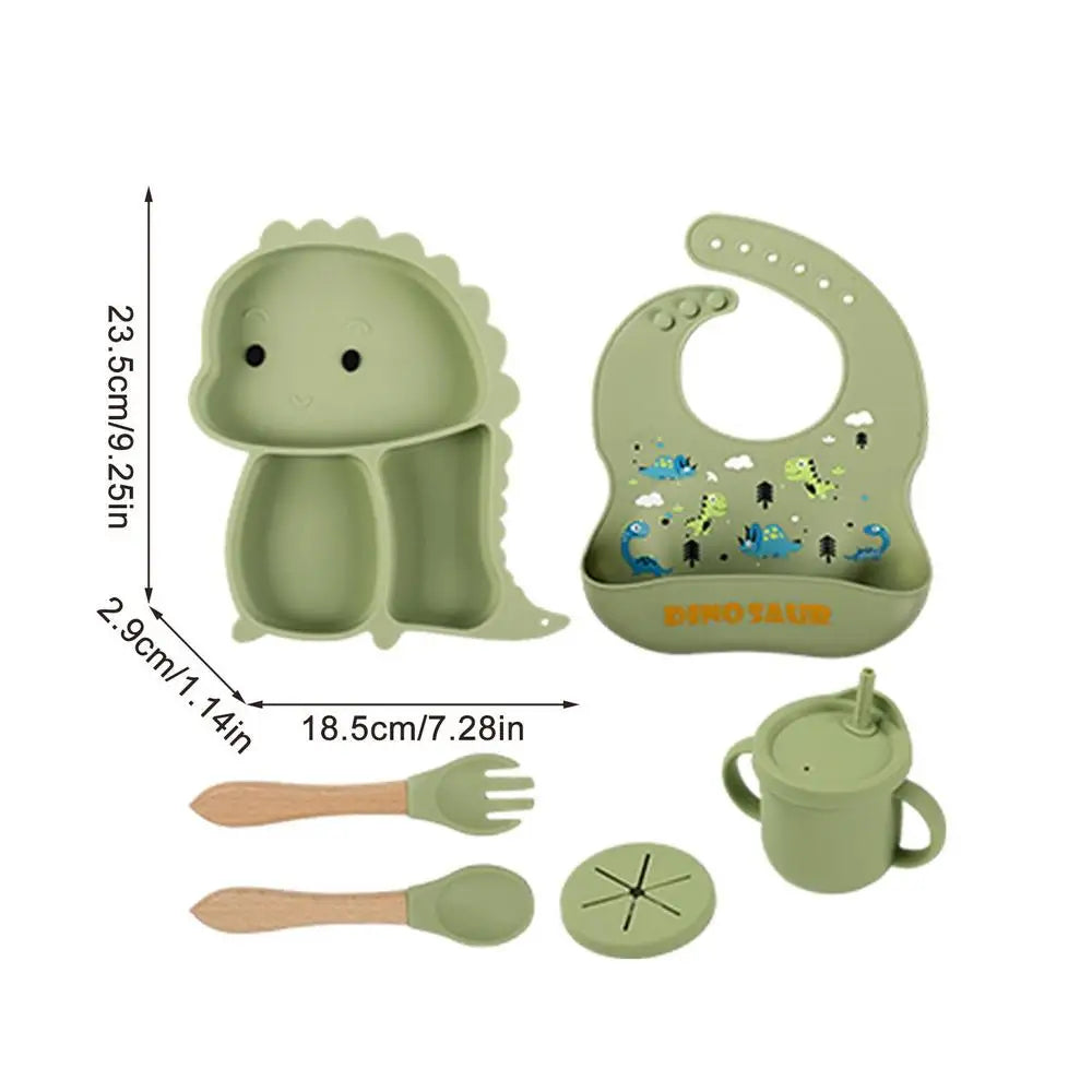 Babymaaltijdset inclusief een dinosaurusbord, slab en bestek.
